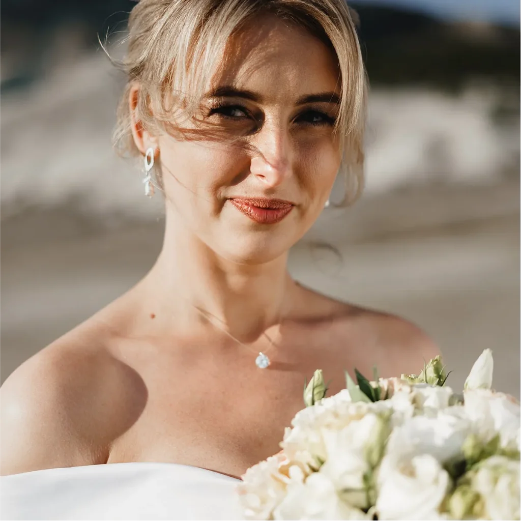 Golden hour wedding portraits in a New Zealand field by Vowly Wedding Video Production.