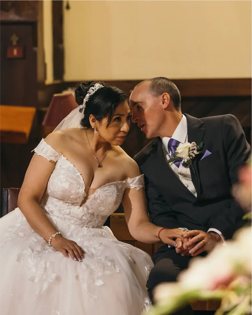 Elegant bride in a lace wedding dress posing in a lush NZ garden, Vowly Wedding Video Production.