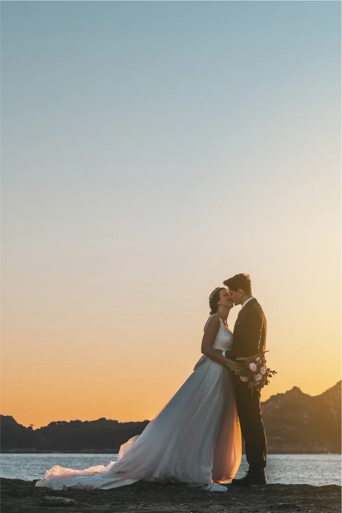 Groom adjusting his suit during preparations in New Zealand, documented by Vowly Wedding Video Production.