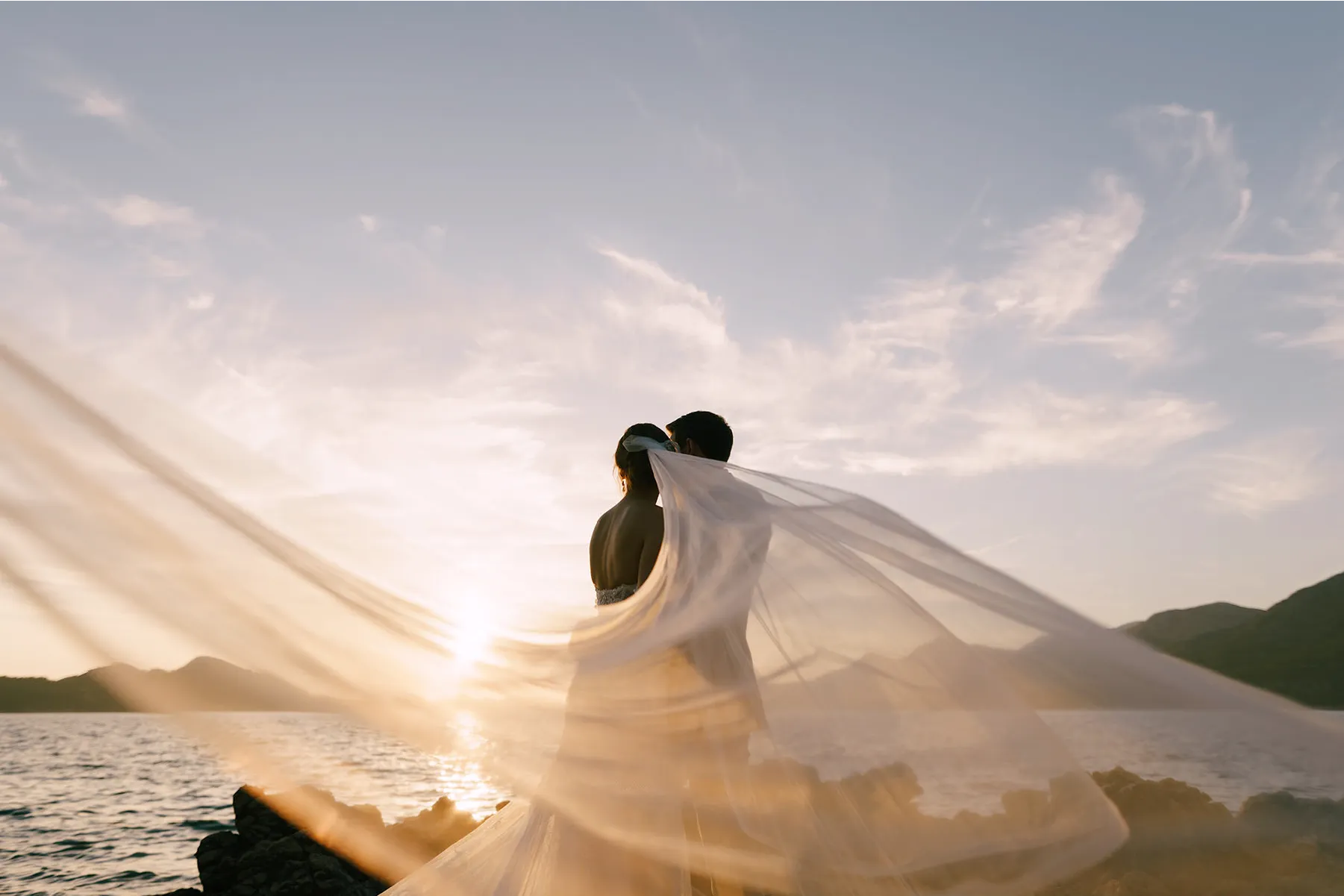Candid wedding photography of a couple laughing outdoors in NZ, captured by Vowly Wedding Video Production.